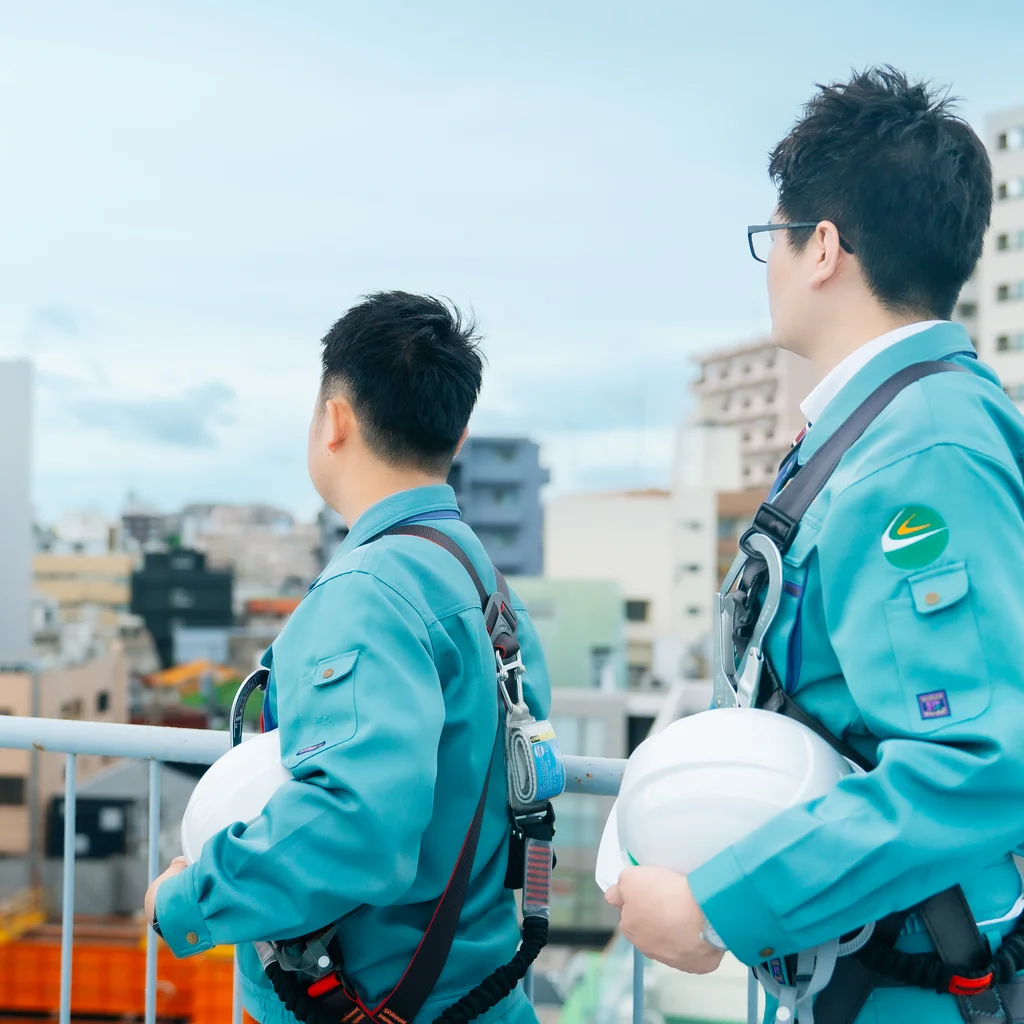 屋上から豊富な建設現場を見渡す社員